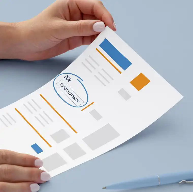 Mani che tengono un documento con codice PDR evidenziato, su sfondo blu con penna a lato.